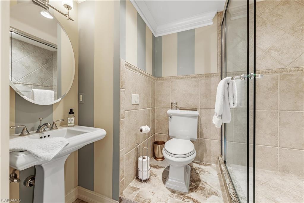 800 River Point Drive, Unit 319 Naples, FL 34102 - Photo 22 of 33 a bathroom with a sink toilet and shower