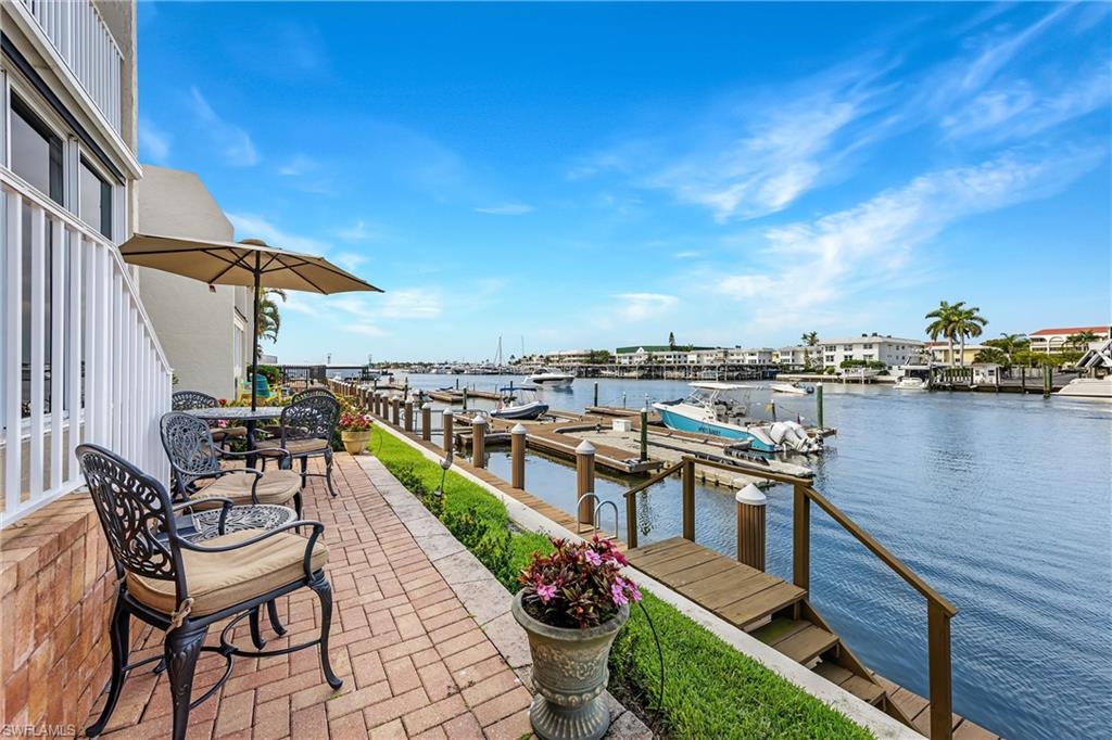 800 River Point Drive, Unit 319 Naples, FL 34102 - Photo 23 of 33 a view of a chairs and table on the terrace
