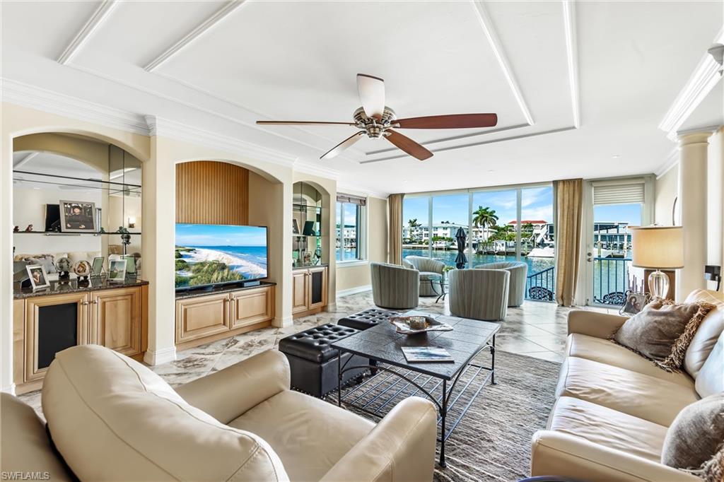 800 River Point Drive, Unit 319 Naples, FL 34102 - Photo 3 of 33 a living room with furniture a chandelier and a dining table