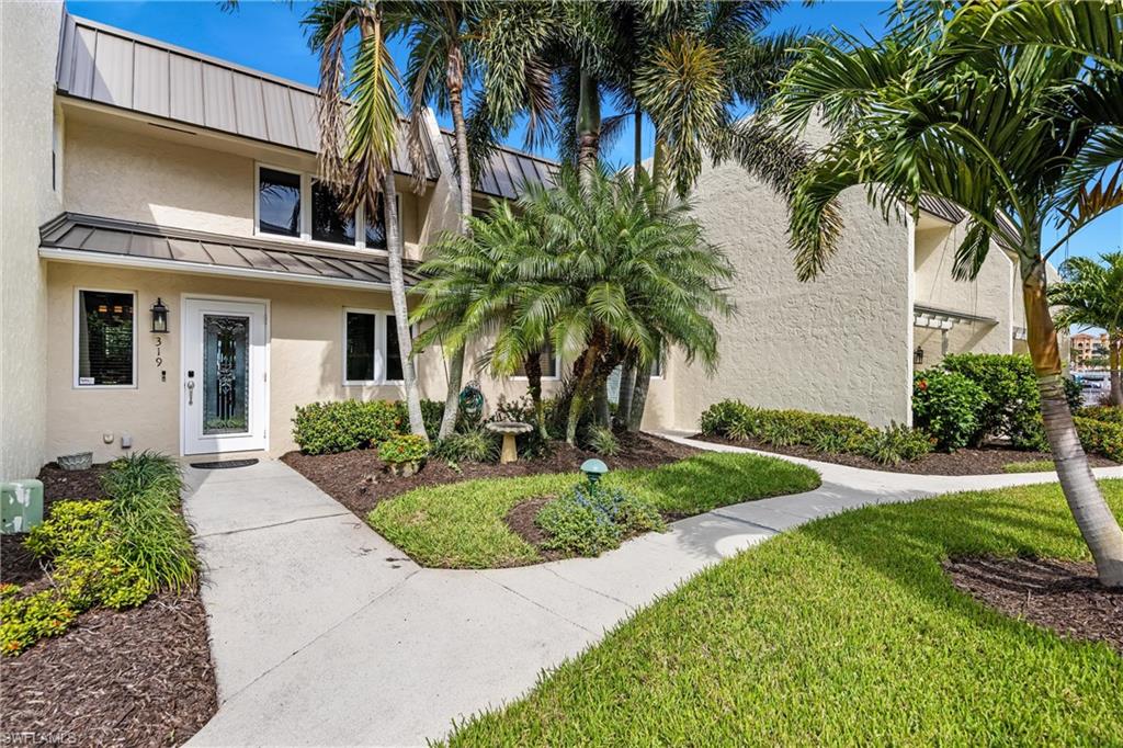 800 River Point Drive, Unit 319 Naples, FL 34102 - Photo 33 of 33 a front view of a house with a garden