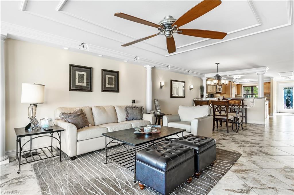800 River Point Drive, Unit 319 Naples, FL 34102 - Photo 5 of 33 a living room with furniture and a table