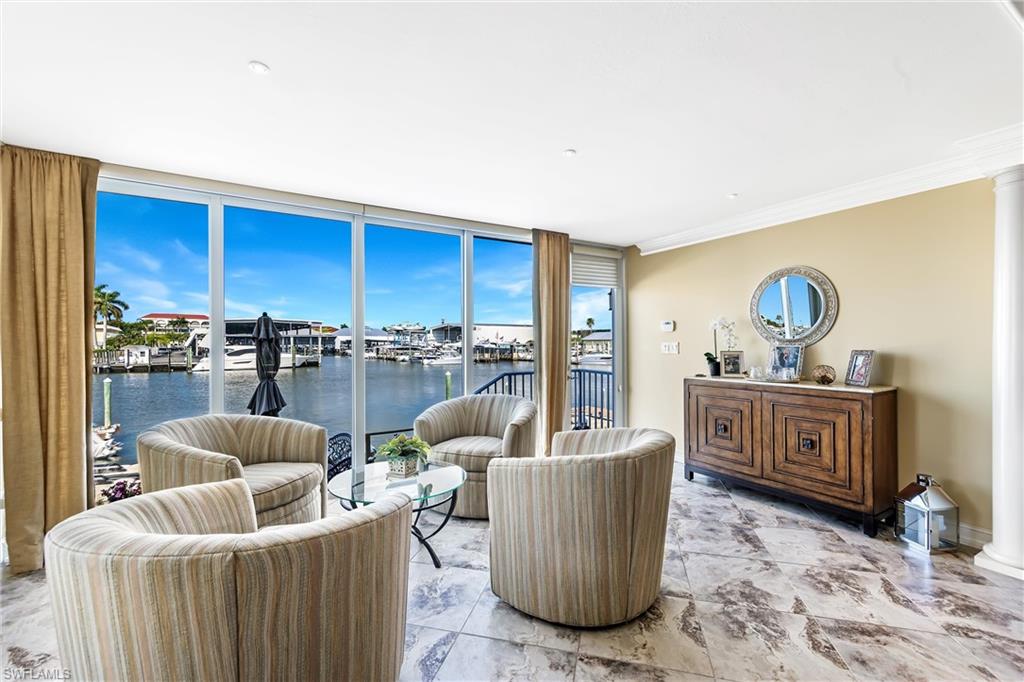 800 River Point Drive, Unit 319 Naples, FL 34102 - Photo 6 of 33 a living room with furniture a couch and a cabinet