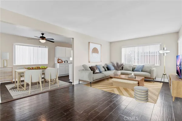 a living room with fireplace furniture and a wooden floor