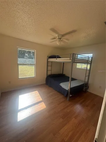 a view of a room with wooden floor and window