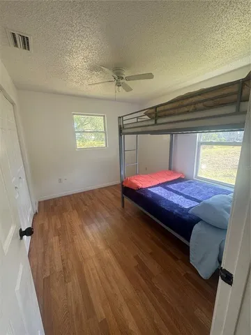 a living room with hard wood floors and a fireplace