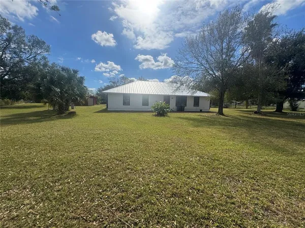 a view of a house with a big yard