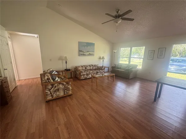 a living room with furniture and wooden floor