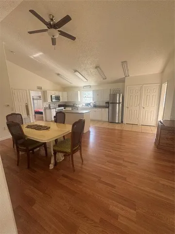 a view of a dining room with furniture and wooden floor