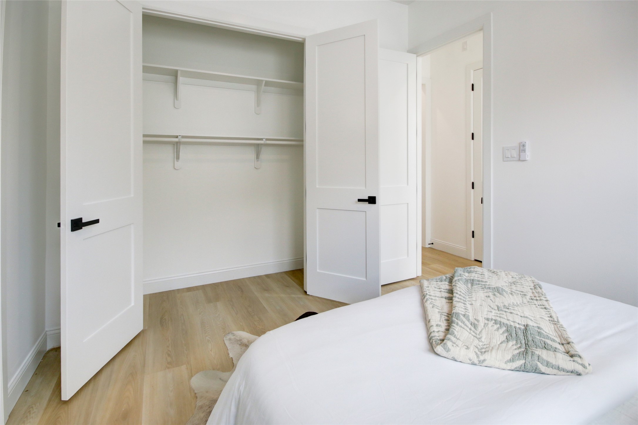 1214 West 24th Street, Unit D Houston, TX 77008 - Photo 34 of 45 a bedroom with a bed and a wooden floor