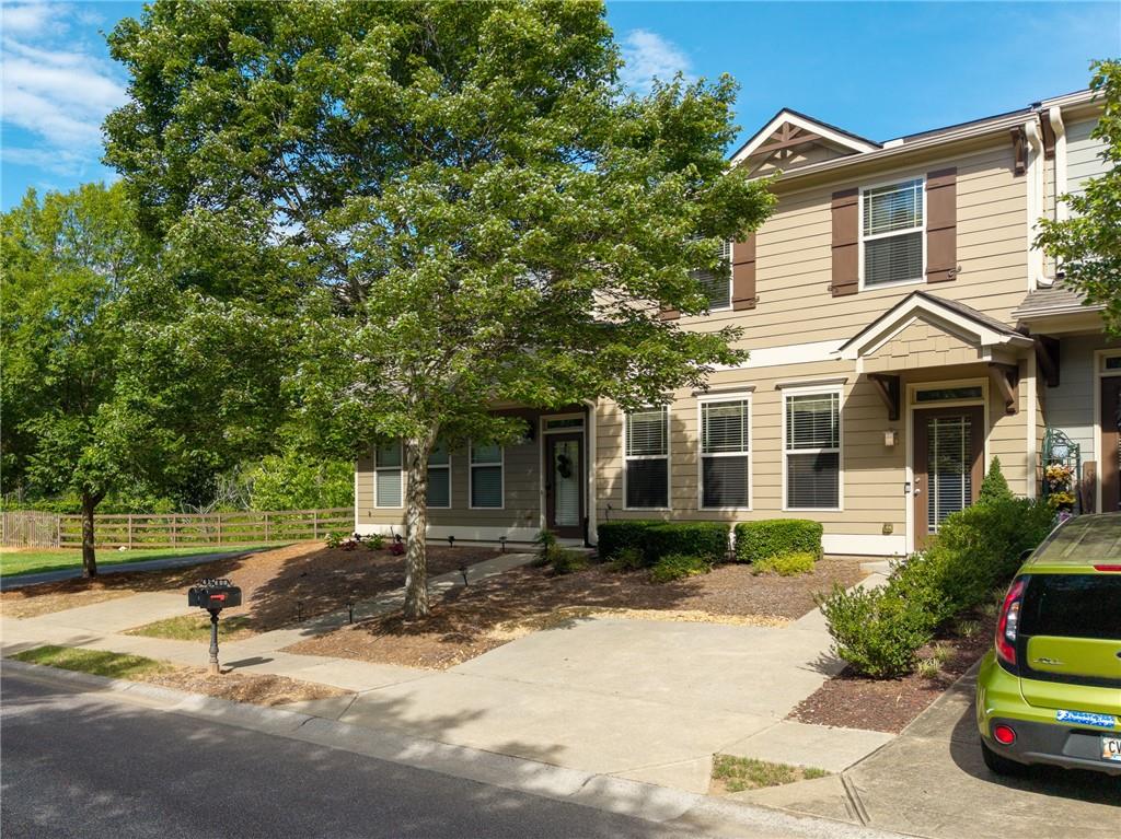 608 Myers Gate Road Ball Ground, GA 30107 - Photo 31 of 31 a front view of a house with a yard and potted plants