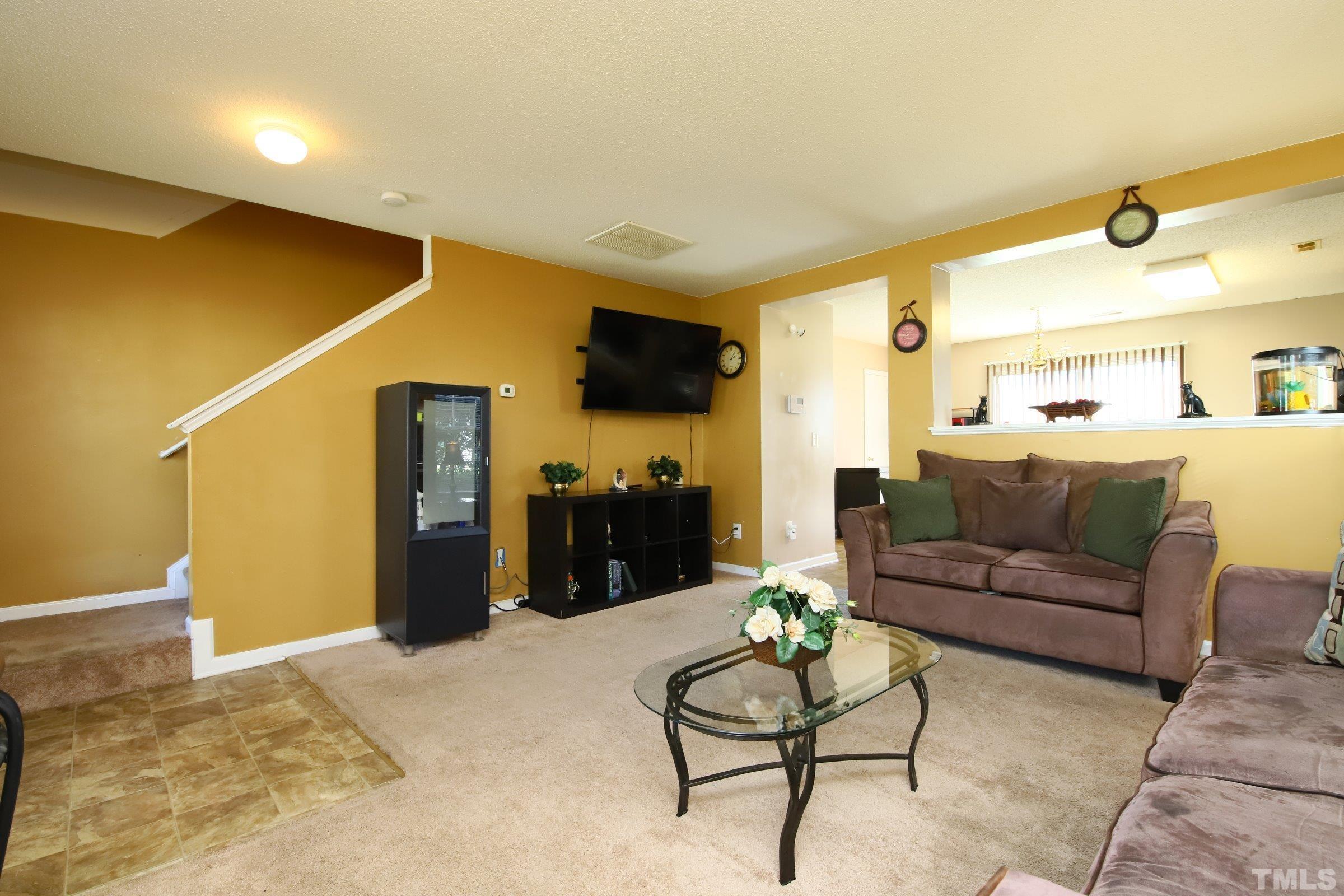 3816 Tryon Ridge Drive Raleigh, NC 27610 - Photo 12 of 28 a living room with furniture and a flat screen tv