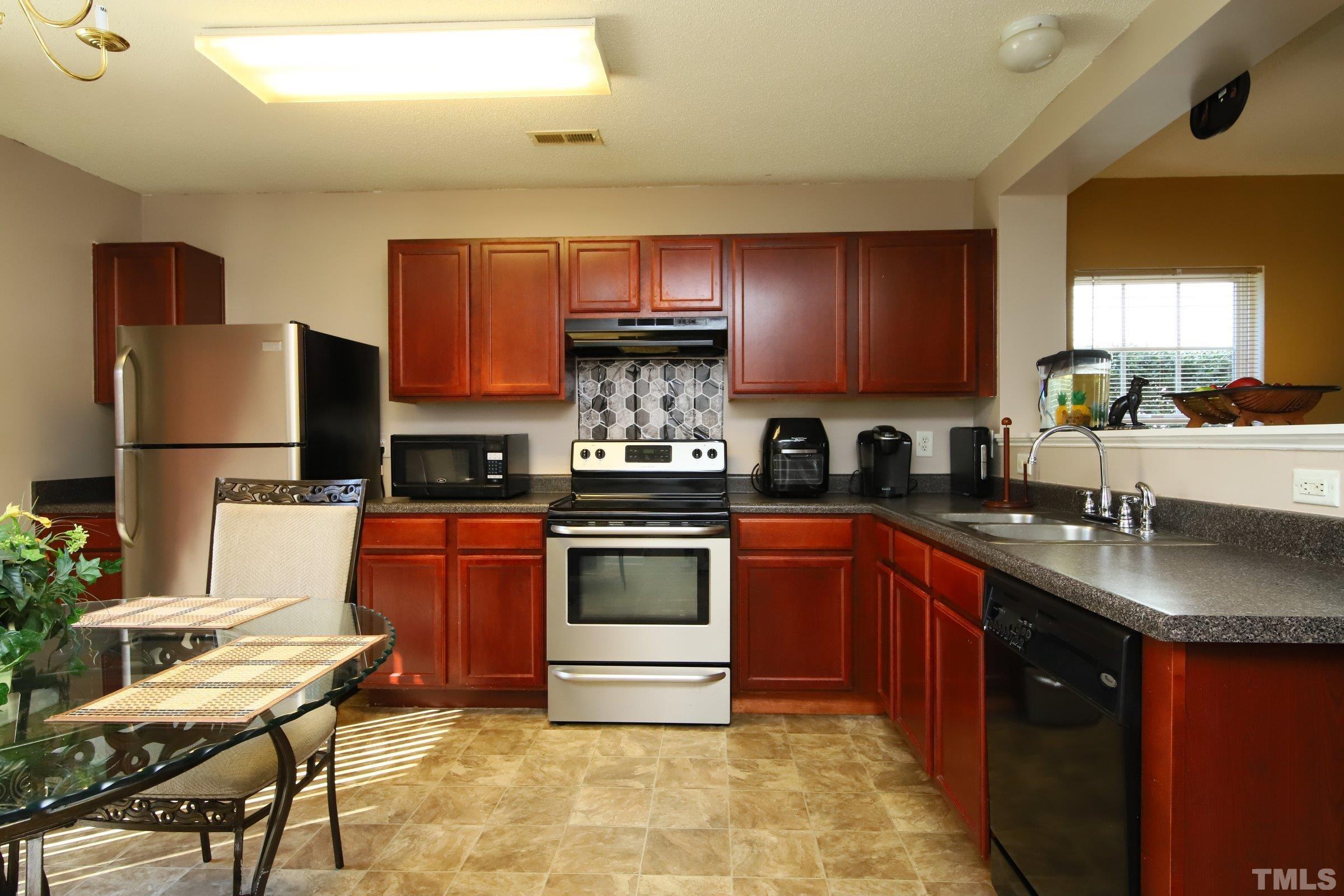 3816 Tryon Ridge Drive Raleigh, NC 27610 - Photo 15 of 28 a kitchen with stainless steel appliances granite countertop a stove a sink dishwasher and a refrigerator