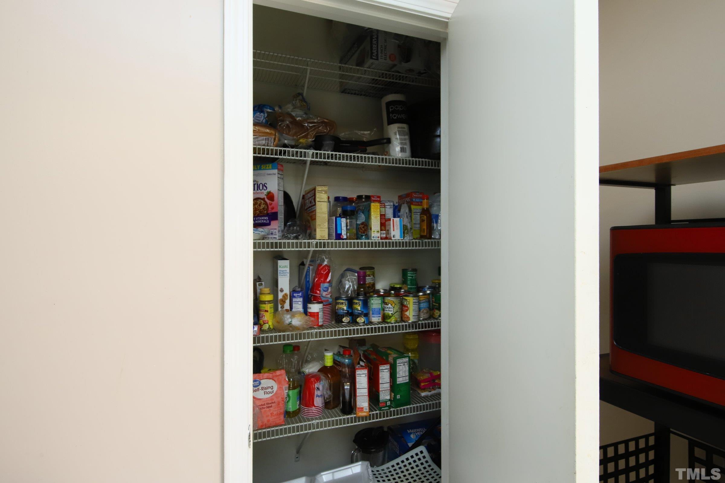 3816 Tryon Ridge Drive Raleigh, NC 27610 - Photo 18 of 28 a shelf with wine bottles and glasses on it