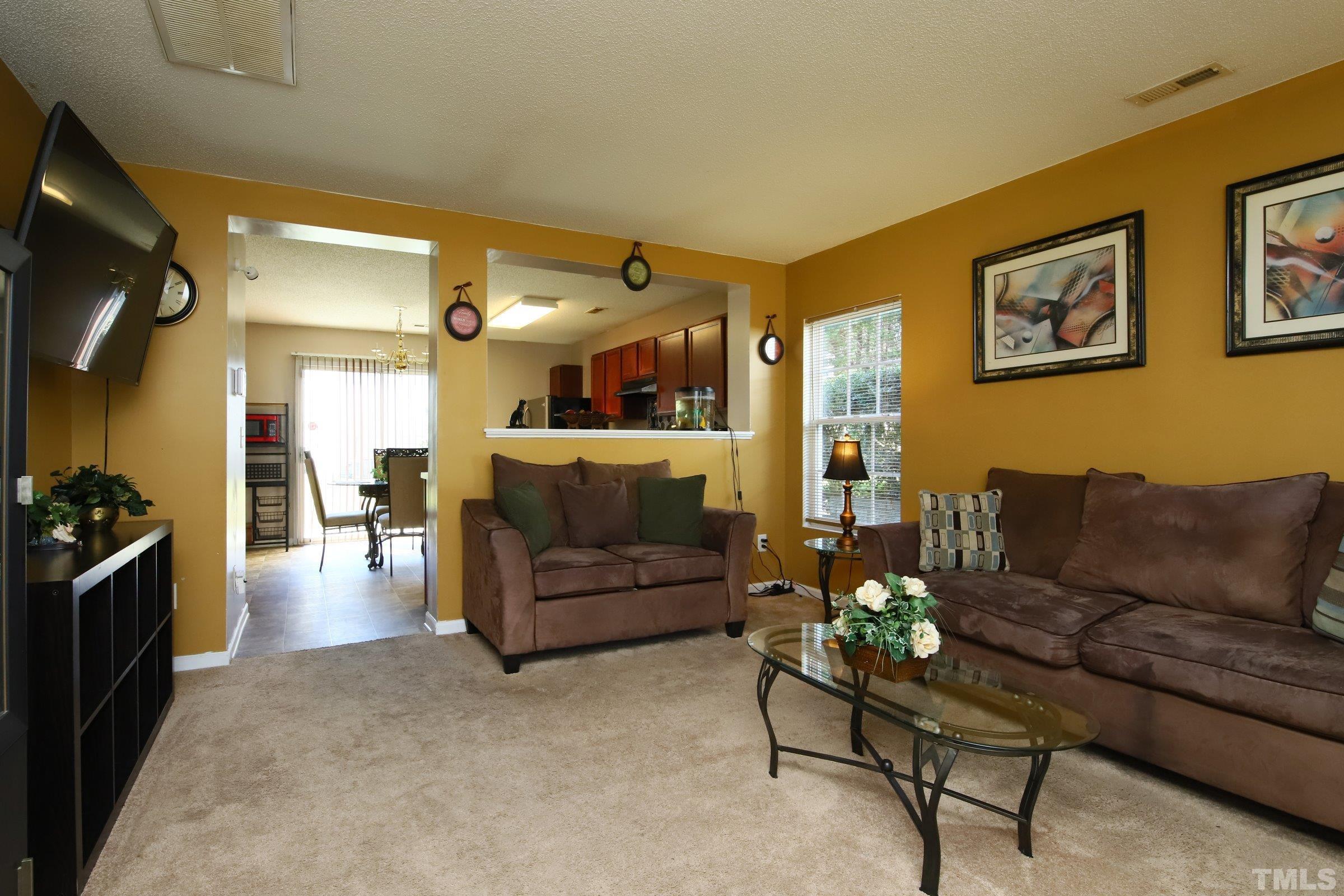 3816 Tryon Ridge Drive Raleigh, NC 27610 - Photo 10 of 28 a living room with furniture and a flat screen tv