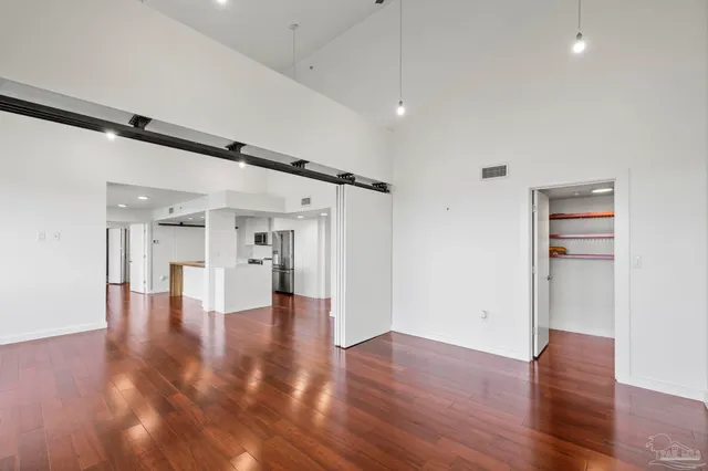 a view of empty room with wooden floor