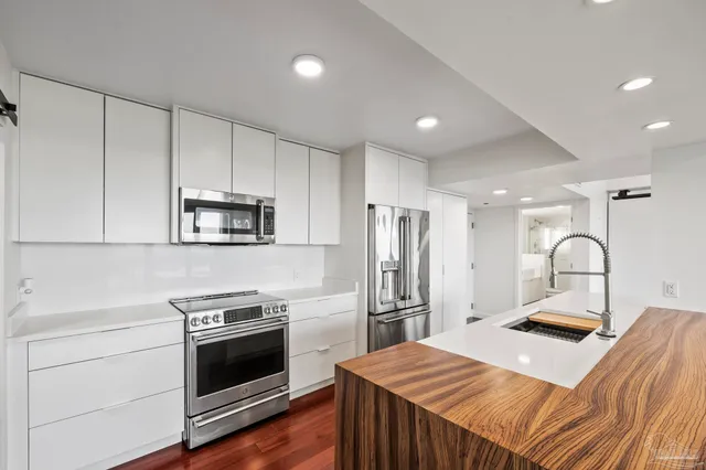 a kitchen with stainless steel appliances a refrigerator stove and microwave