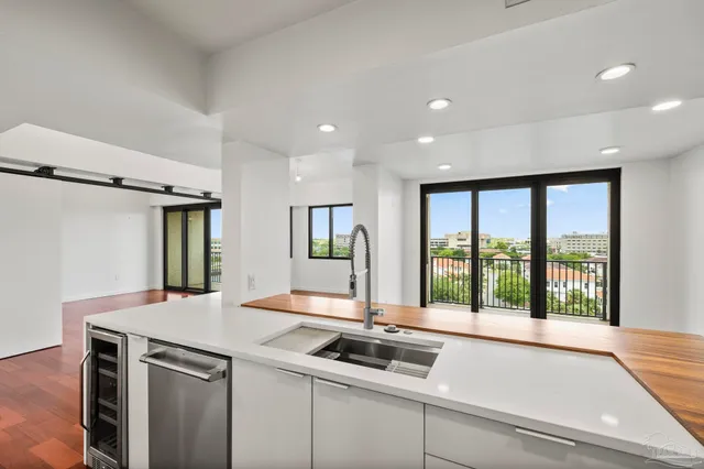 a kitchen with a sink and large window