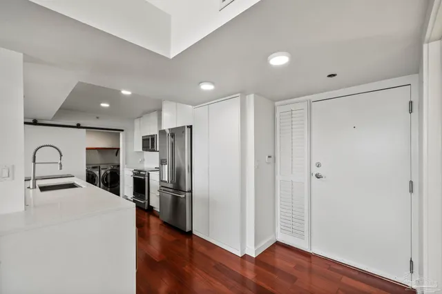 a kitchen with stainless steel appliances granite countertop a refrigerator and a sink