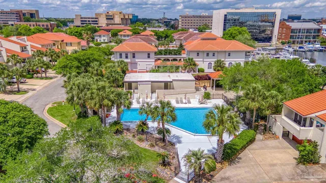 an aerial view of a houses with an outdoor space and lakeside