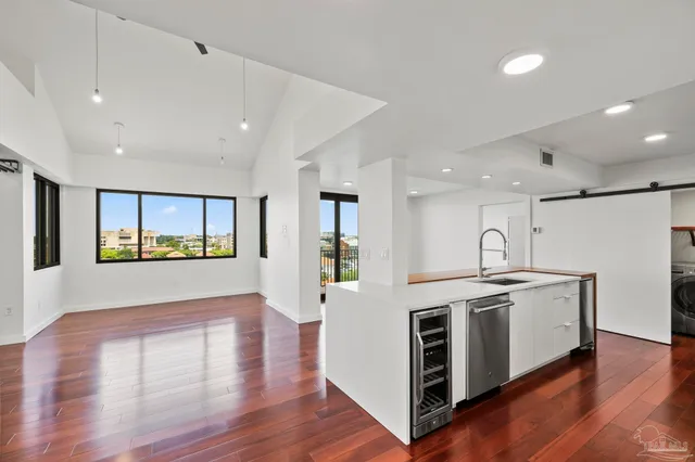 a open kitchen with stainless steel appliances granite countertop a stove and a refrigerator