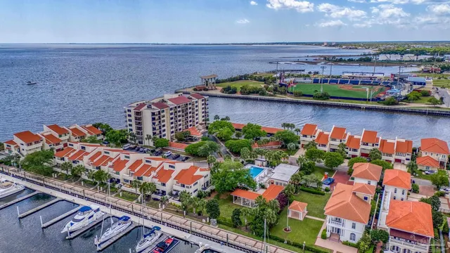 a view of a terrace with lawn chairs and iron fence
