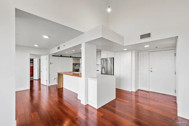 a view of kitchen with cabinets and wooden floor