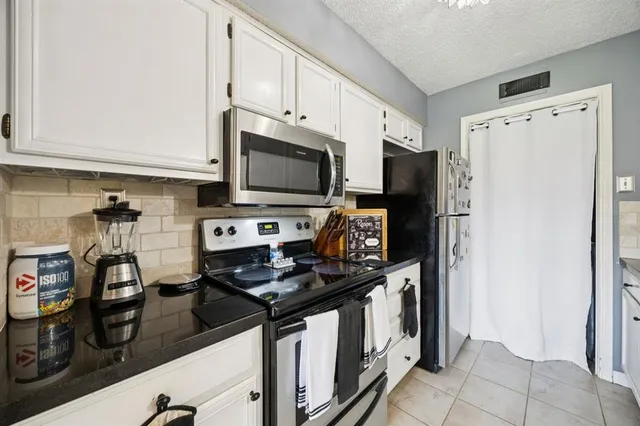 a kitchen with stainless steel appliances a refrigerator stove and microwave