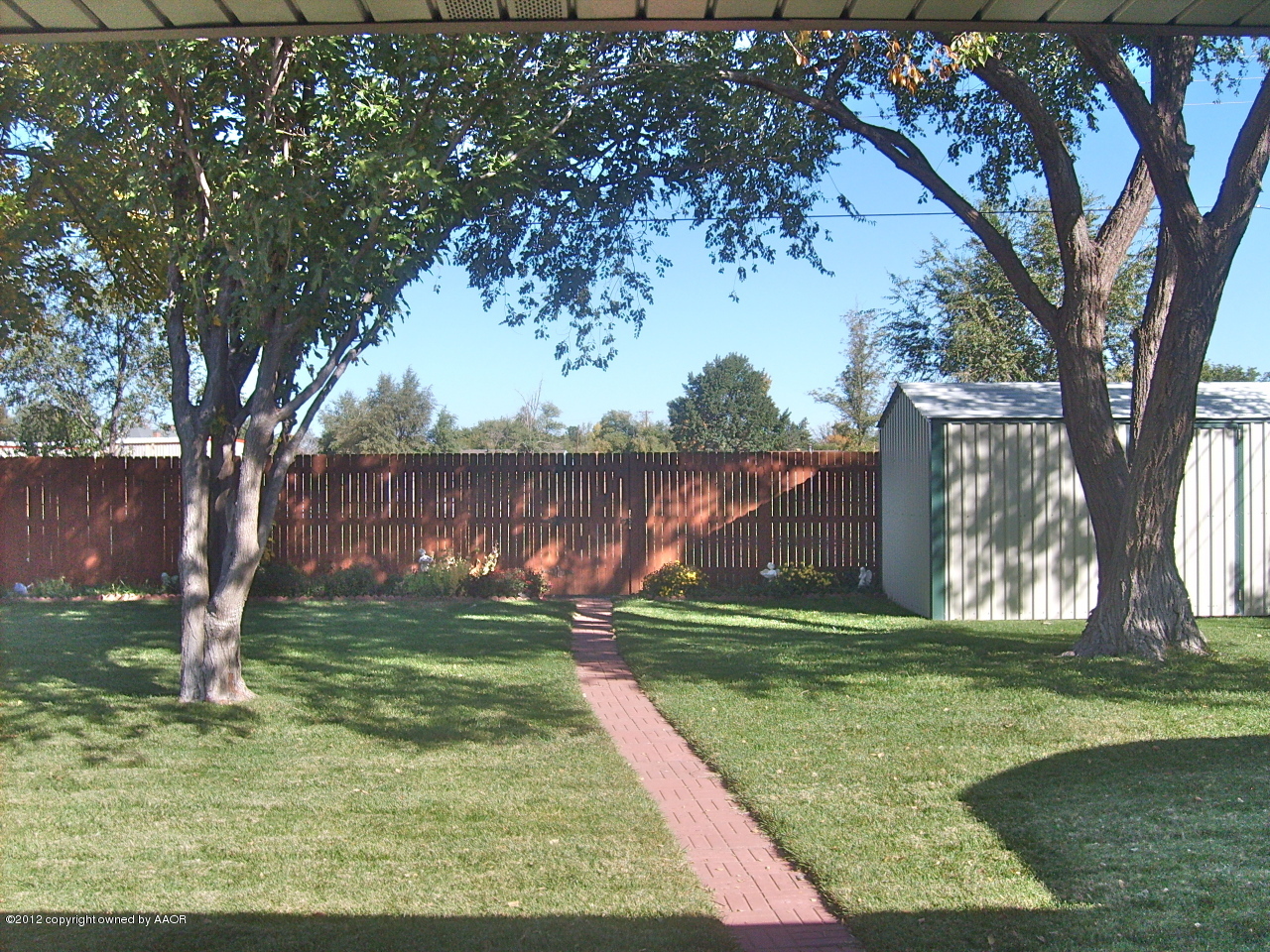 4814 Tulip Avenue Amarillo, TX 79110 - Photo 19 of 27 a view of a yard with a tree