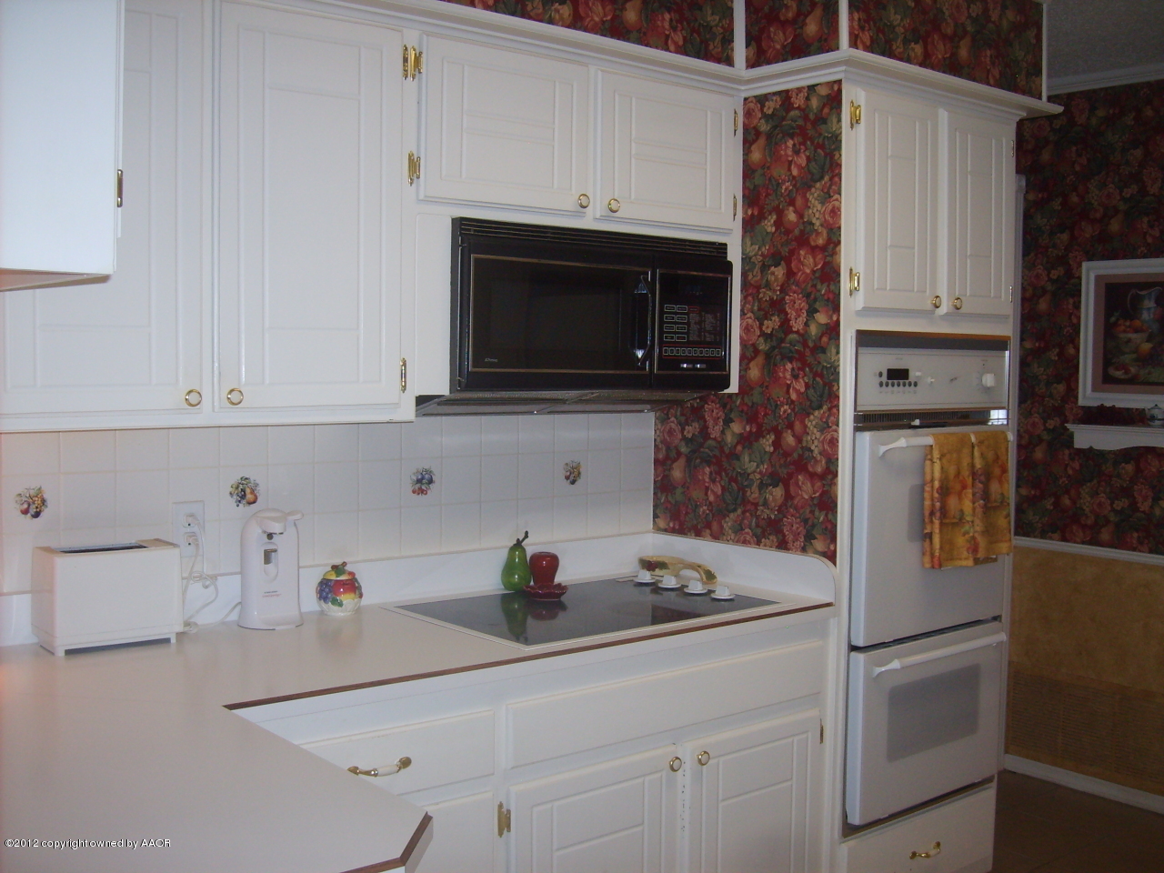 4814 Tulip Avenue Amarillo, TX 79110 - Photo 5 of 27 a kitchen with a sink a microwave and cabinets