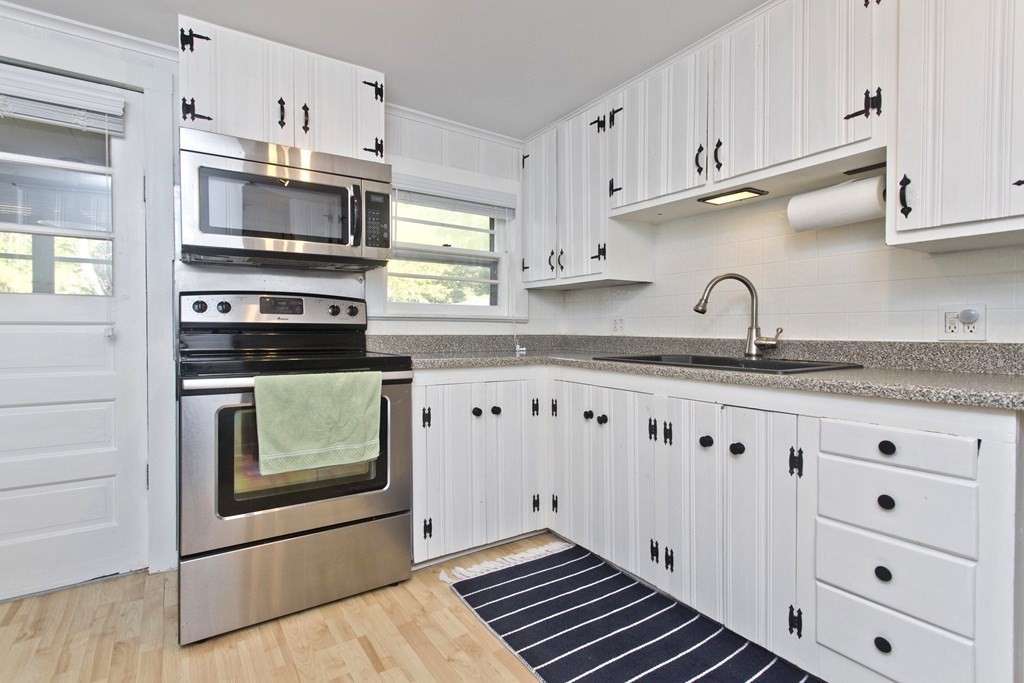 520 Dutchess Street Springfield, MA 01129 - Photo 3 of 31 a kitchen with granite countertop white cabinets and stainless steel appliances