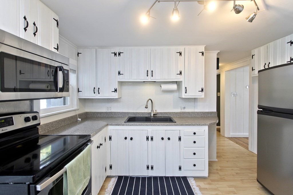 520 Dutchess Street Springfield, MA 01129 - Photo 4 of 31 a kitchen with granite countertop a sink stove and refrigerator