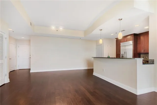 a view of a kitchen with a sink and a refrigerator