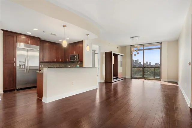 a view of a kitchen with a sink and a refrigerator