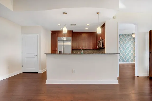a view of a kitchen with a refrigerator and a sink