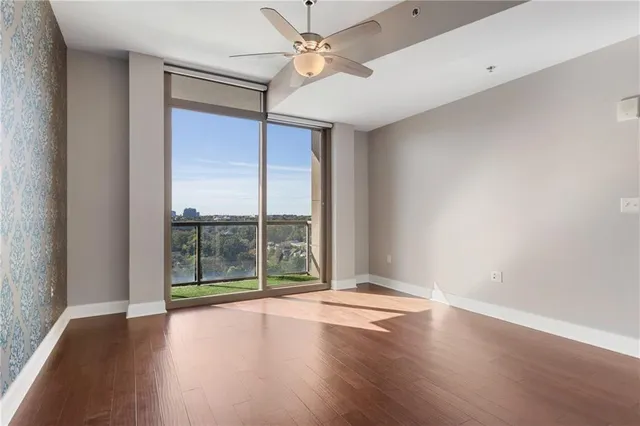 a view of room with window and wooden floor