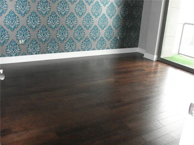 a view of a room with wooden floor and window