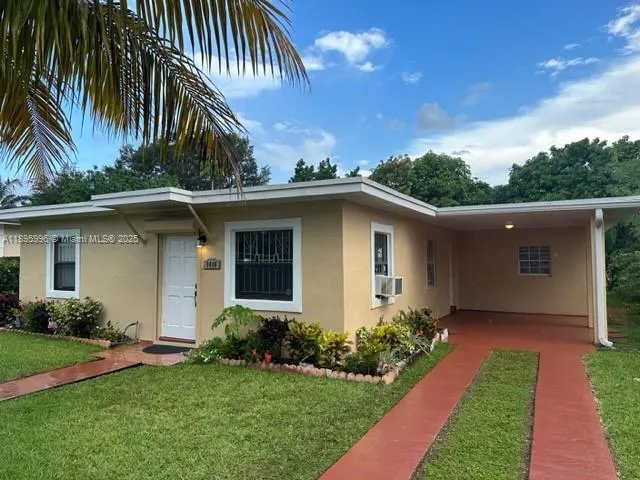a front view of house with yard and trees
