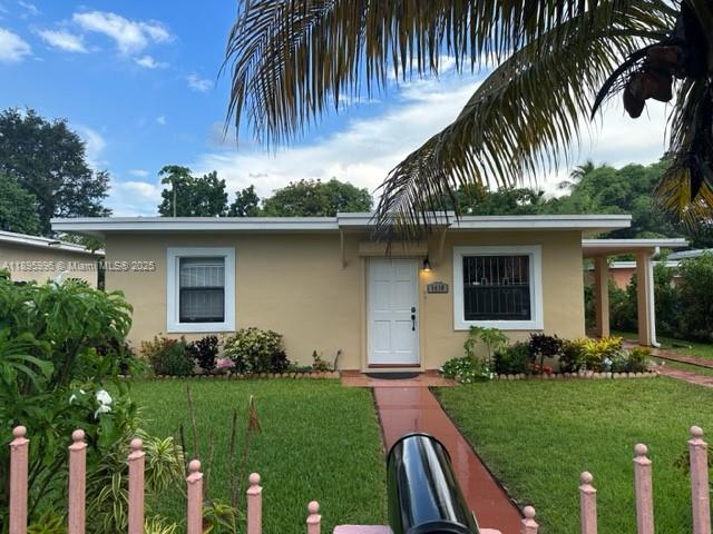 1410 Northwest 123rd Street, Unit 1410 North Miami, FL 33167 - Photo 3 of 5 a front view of house with yard and green space