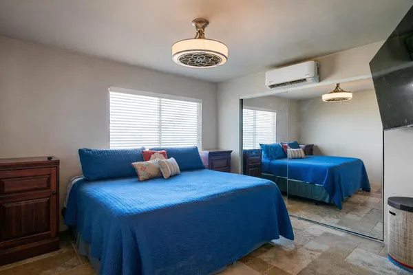 a bedroom with two beds and a chandelier