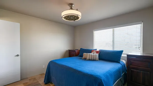 a bedroom with bed and a window