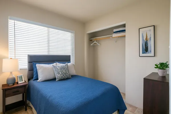 a bedroom with a bed and lamps