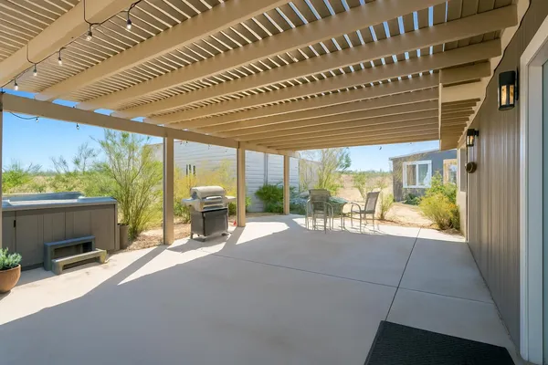 a view of a porch with furniture and garden