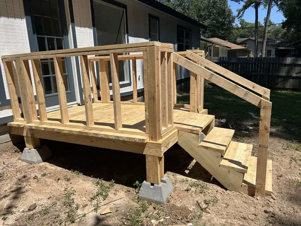 a view of house with backyard and deck