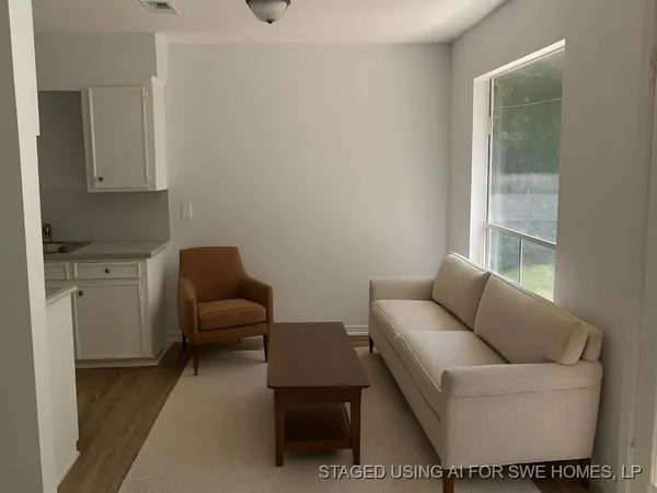 a living room with furniture and a window