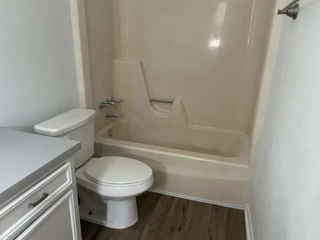 a bathroom with a toilet and a shower