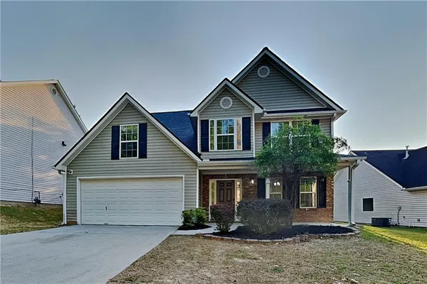 a front view of a house with a yard and garage