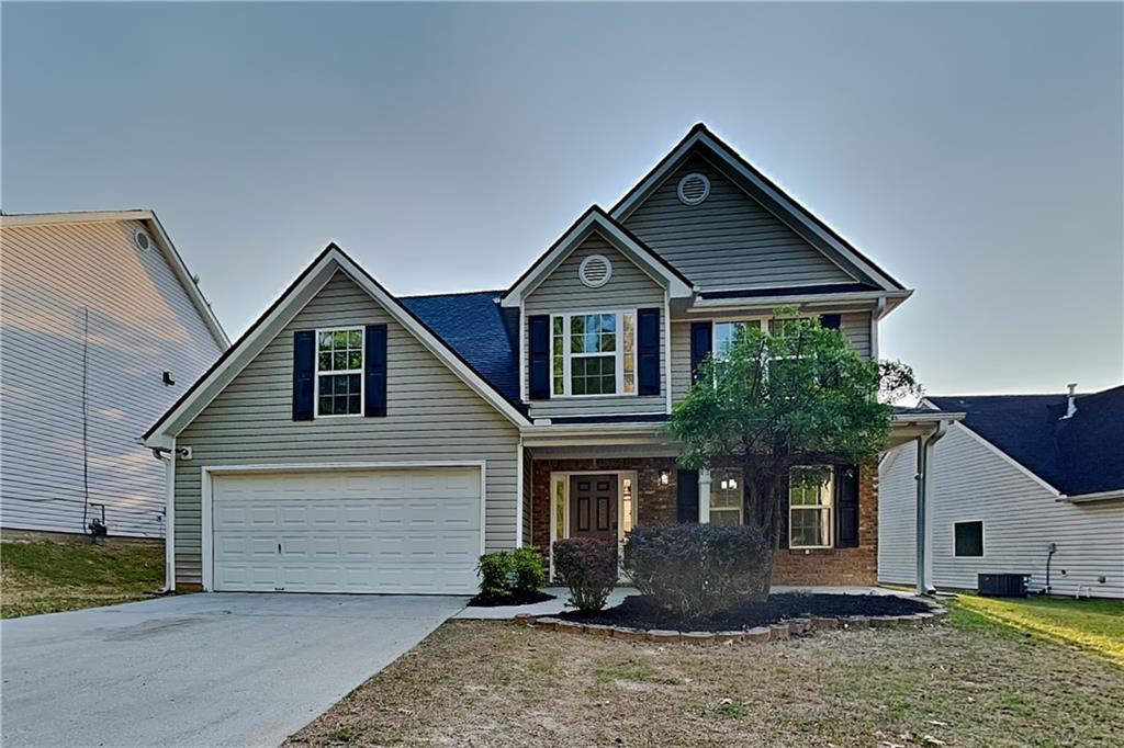 1595 Stephens Pond View Loganville, GA 30052 - Photo 1 of 22 a front view of a house with a yard and garage