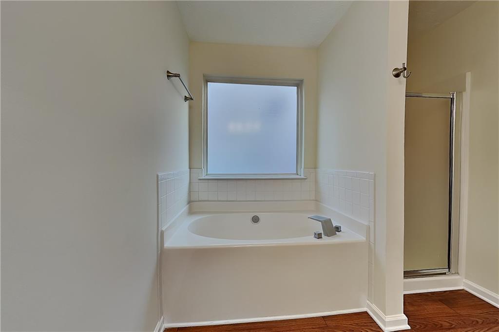 1595 Stephens Pond View Loganville, GA 30052 - Photo 11 of 22 a white bath tub sitting in a bathroom