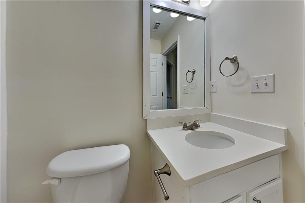 1595 Stephens Pond View Loganville, GA 30052 - Photo 18 of 22 a bathroom with a sink a toilet and a mirror