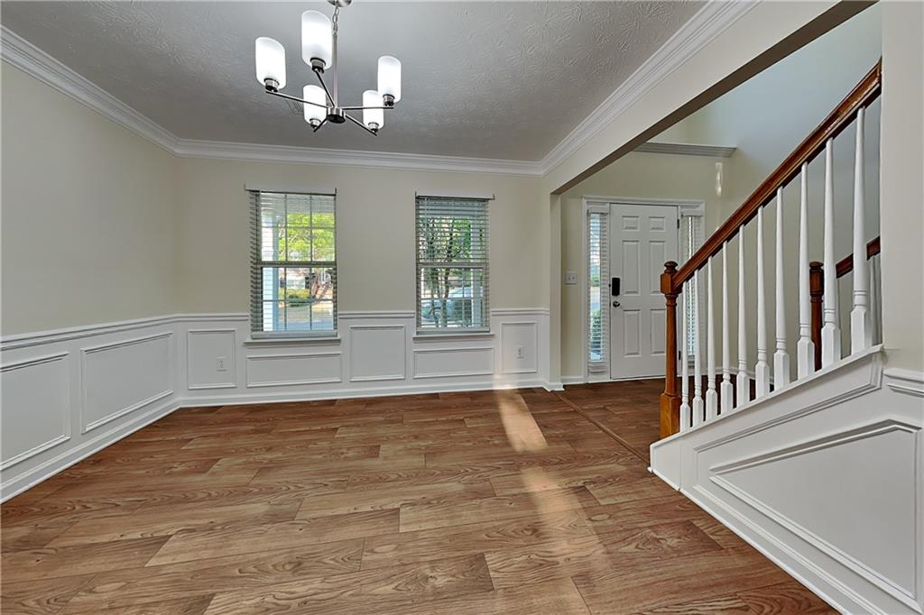 1595 Stephens Pond View Loganville, GA 30052 - Photo 6 of 22 a view of an empty room with wooden floor and a window